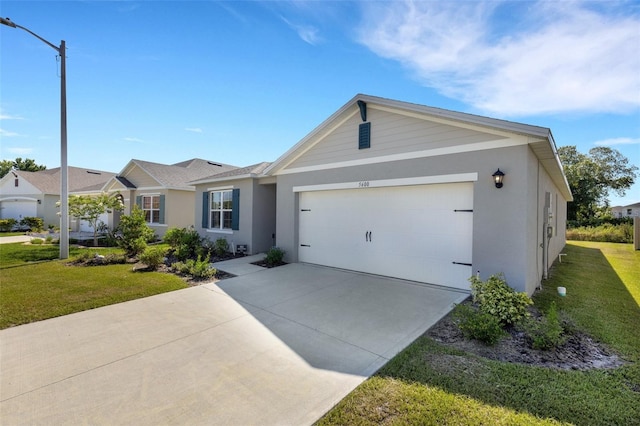 ranch-style house featuring an attached garage, driveway, a front lawn, and stucco siding