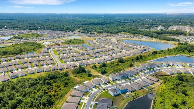 birds eye view of property with a water view and a residential view