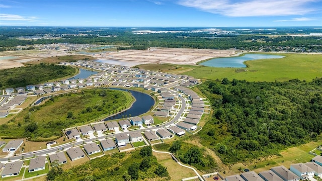 drone / aerial view with a water view and a residential view