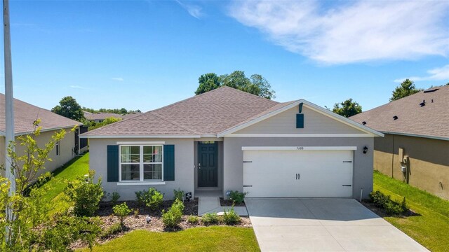 single story home with stucco siding, a shingled roof, concrete driveway, a garage, and a front lawn