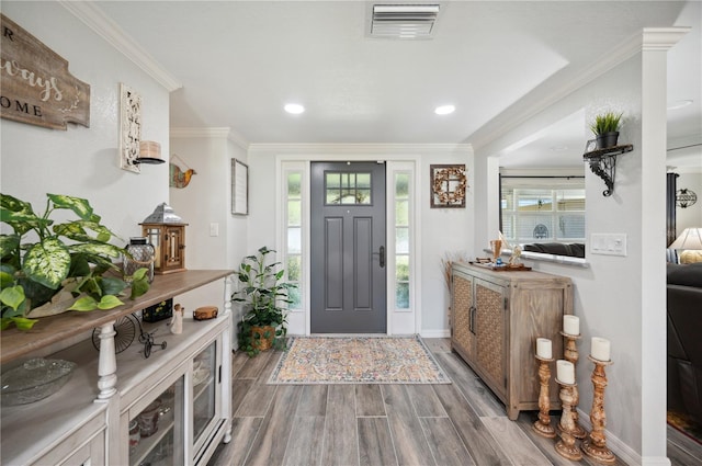 foyer entrance featuring crown molding