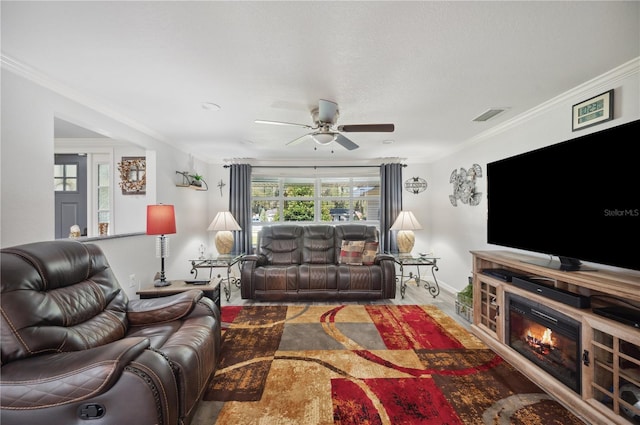 living room featuring ceiling fan and crown molding