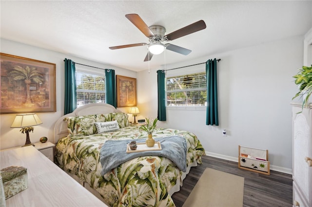 bedroom with ceiling fan and dark hardwood / wood-style floors