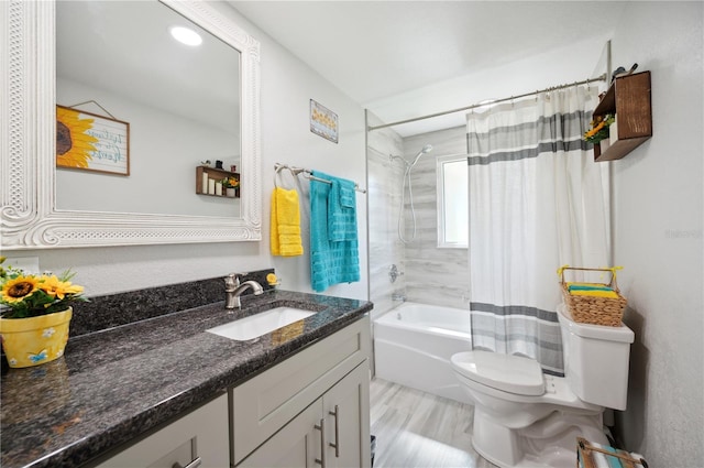 full bathroom featuring shower / bath combo, toilet, and vanity