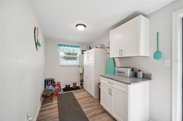 kitchen featuring white cabinetry and light wood-type flooring