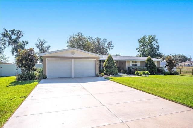 ranch-style house featuring a garage and a front lawn