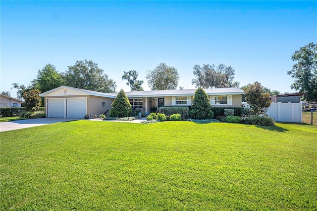 ranch-style home featuring a garage and a front lawn