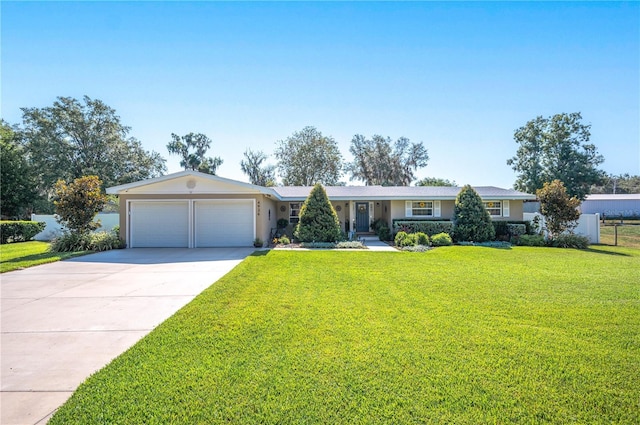 ranch-style house featuring a garage and a front lawn