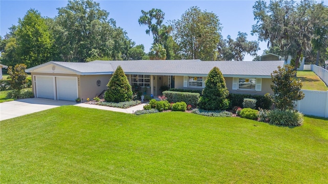 ranch-style home featuring a front yard and a garage