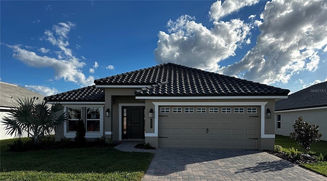 view of front of home with a front lawn and a garage