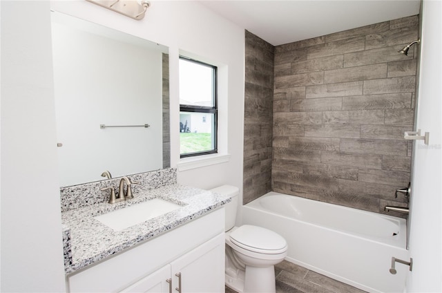 full bathroom featuring toilet, vanity, wood-type flooring, and tiled shower / bath