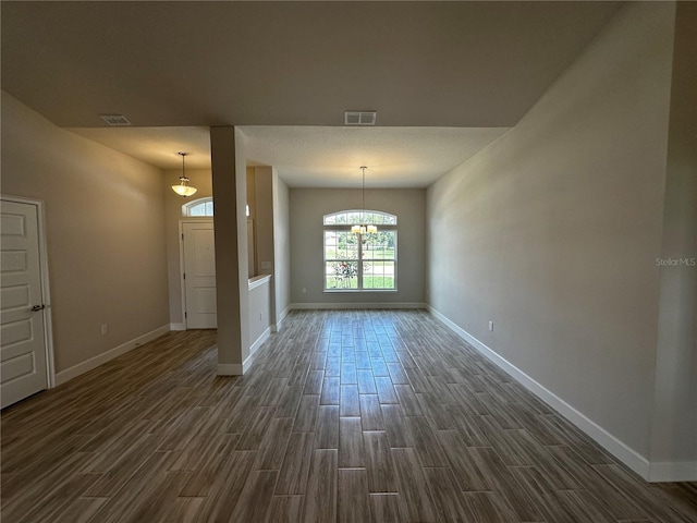 interior space featuring dark wood-type flooring and an inviting chandelier