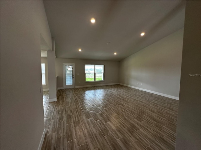 unfurnished living room with dark wood-type flooring