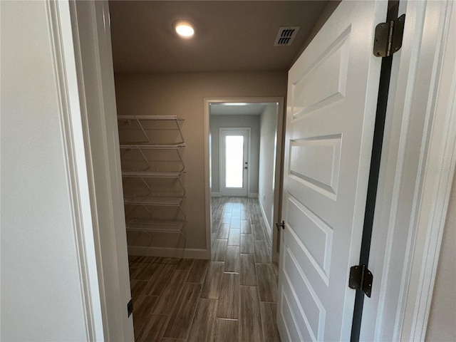 corridor with dark hardwood / wood-style floors