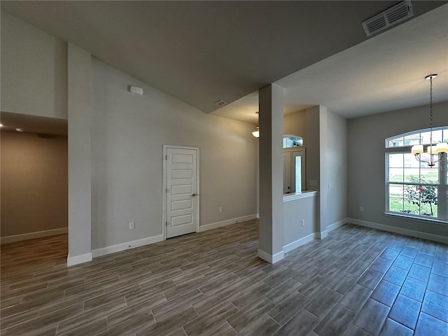 unfurnished living room with a chandelier and lofted ceiling