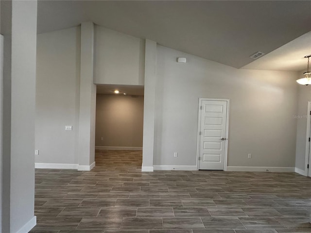 empty room featuring hardwood / wood-style flooring and high vaulted ceiling