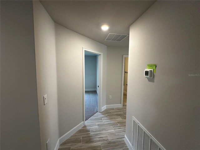 hallway with light wood-type flooring