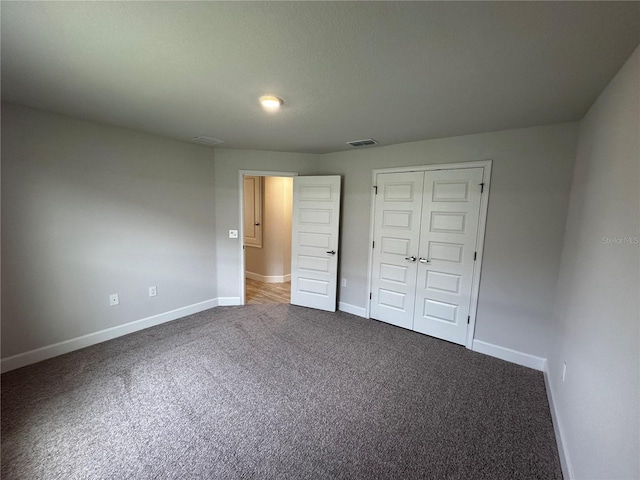 unfurnished bedroom with carpet floors and a closet