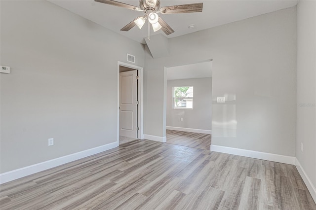 unfurnished room featuring ceiling fan, light hardwood / wood-style floors, and vaulted ceiling