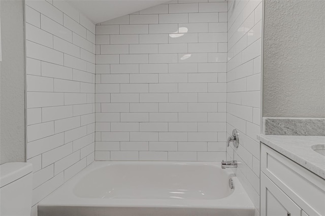 full bathroom with vanity, toilet, and tiled shower / bath