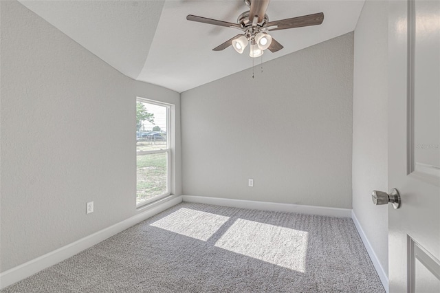 carpeted empty room featuring ceiling fan and lofted ceiling