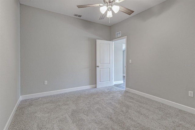 carpeted spare room featuring ceiling fan