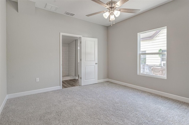 empty room featuring carpet flooring and ceiling fan