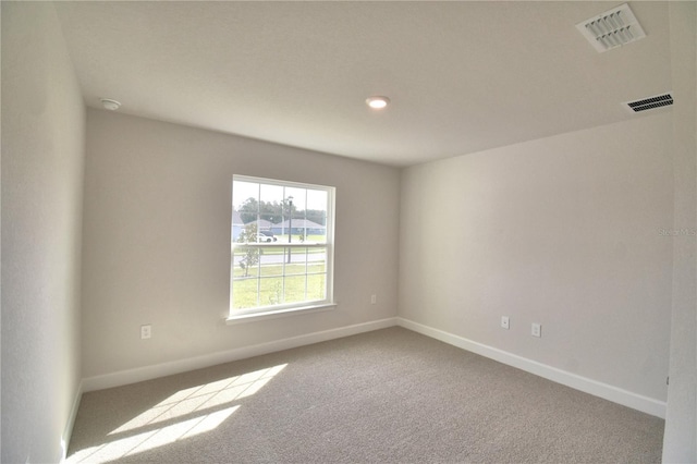 empty room featuring light colored carpet