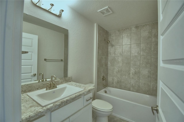 full bathroom with vanity, toilet, and tiled shower / bath