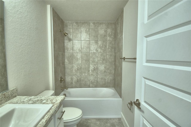 full bathroom with vanity, tiled shower / bath combo, and toilet