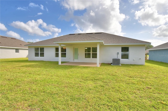 back of house with a patio area, a yard, and central AC