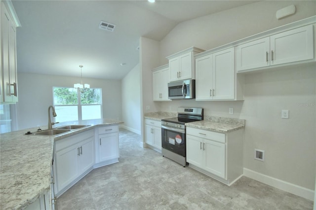 kitchen with white cabinetry, sink, stainless steel appliances, and vaulted ceiling