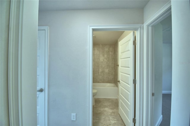 bathroom featuring a bathtub and toilet