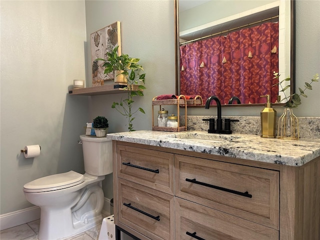 bathroom with tile patterned floors, vanity, and toilet