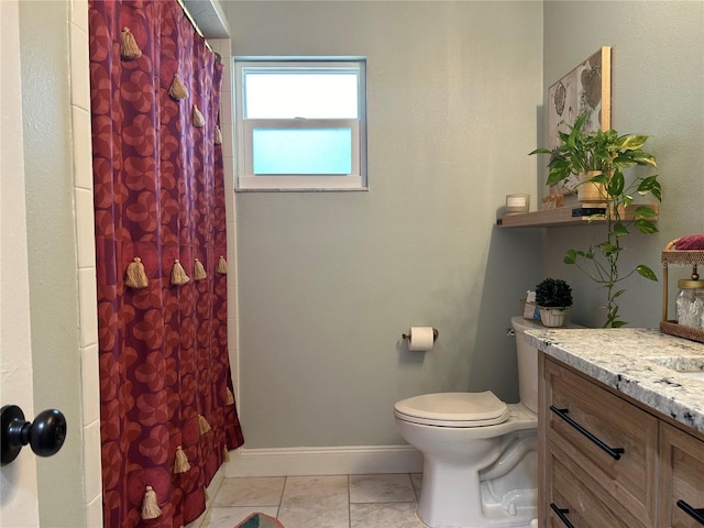 bathroom with tile patterned floors, vanity, toilet, and walk in shower