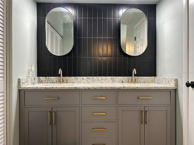 bathroom featuring vanity and tasteful backsplash