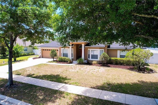 ranch-style home with a front yard and a garage