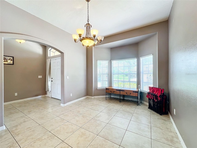 interior space featuring a chandelier and light tile patterned floors