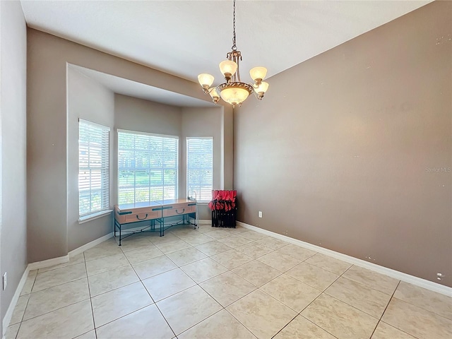 unfurnished room with light tile patterned floors and an inviting chandelier