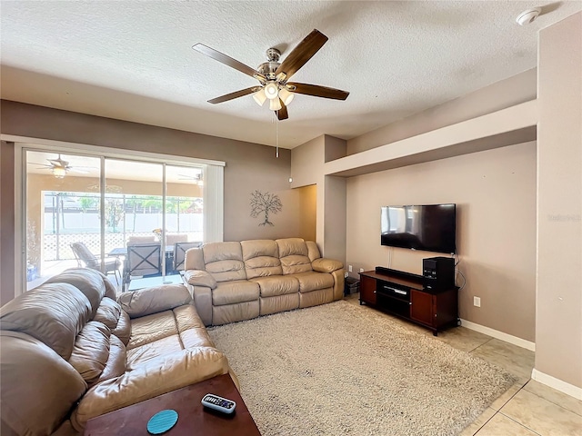 tiled living room featuring ceiling fan and a textured ceiling