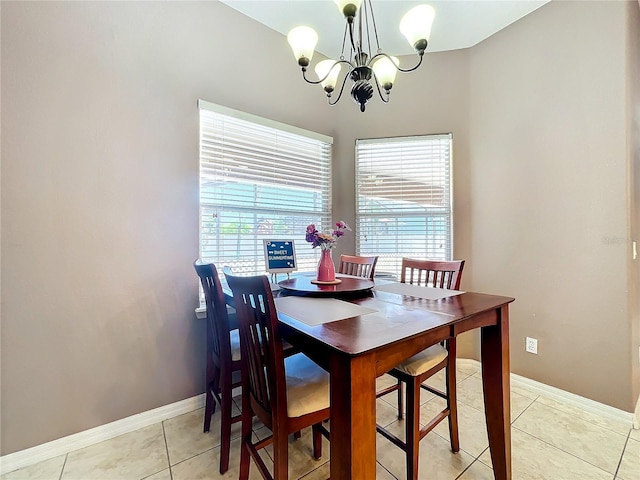 tiled dining room with an inviting chandelier and plenty of natural light