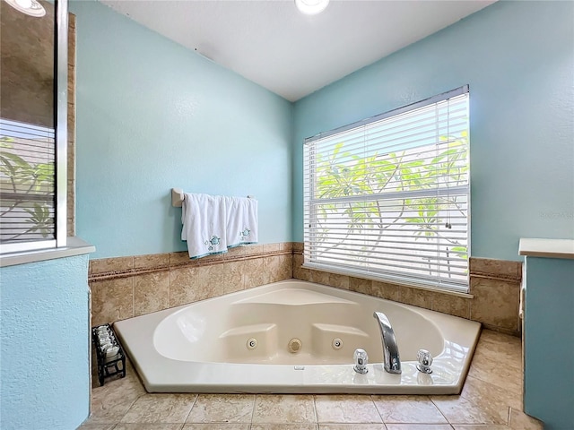 bathroom with tile patterned floors and tiled tub