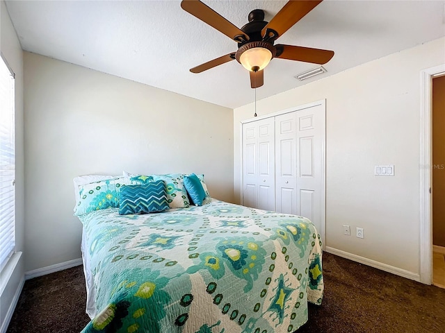 carpeted bedroom featuring a closet and ceiling fan