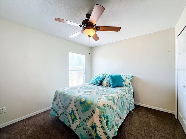 carpeted bedroom featuring a textured ceiling, a closet, and ceiling fan