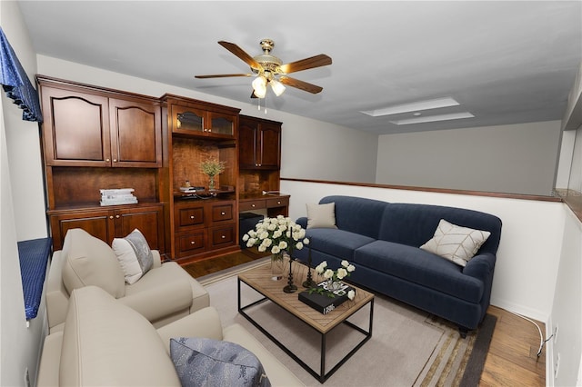 living room featuring light wood-type flooring and ceiling fan