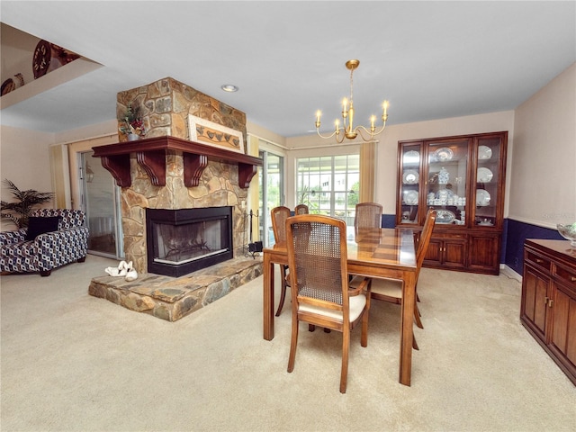 carpeted dining area featuring a fireplace and a notable chandelier