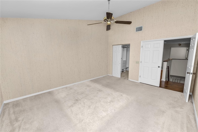 unfurnished bedroom with ceiling fan, carpet, and high vaulted ceiling