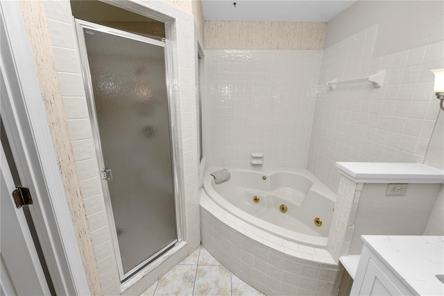 bathroom featuring tile patterned floors, vanity, and shower with separate bathtub