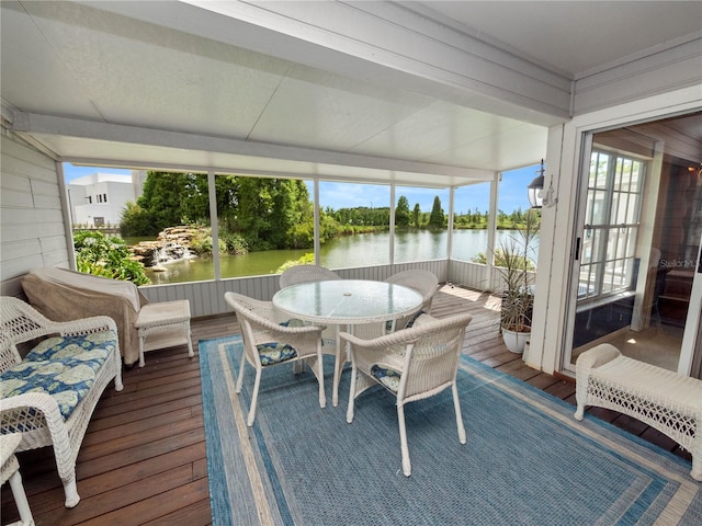 sunroom / solarium with a water view