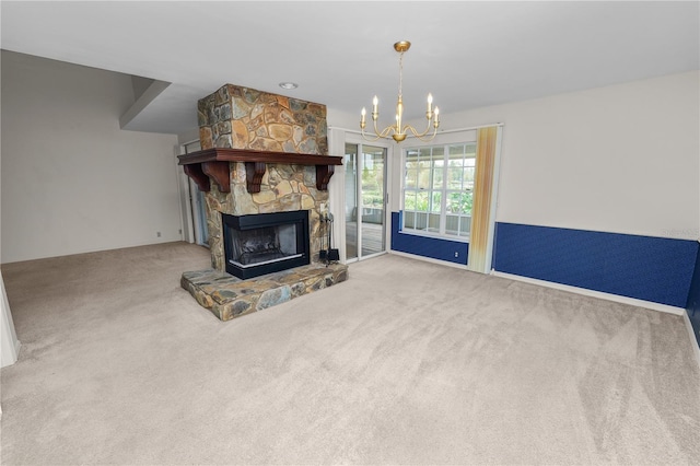 living room with an inviting chandelier, a fireplace, and carpet